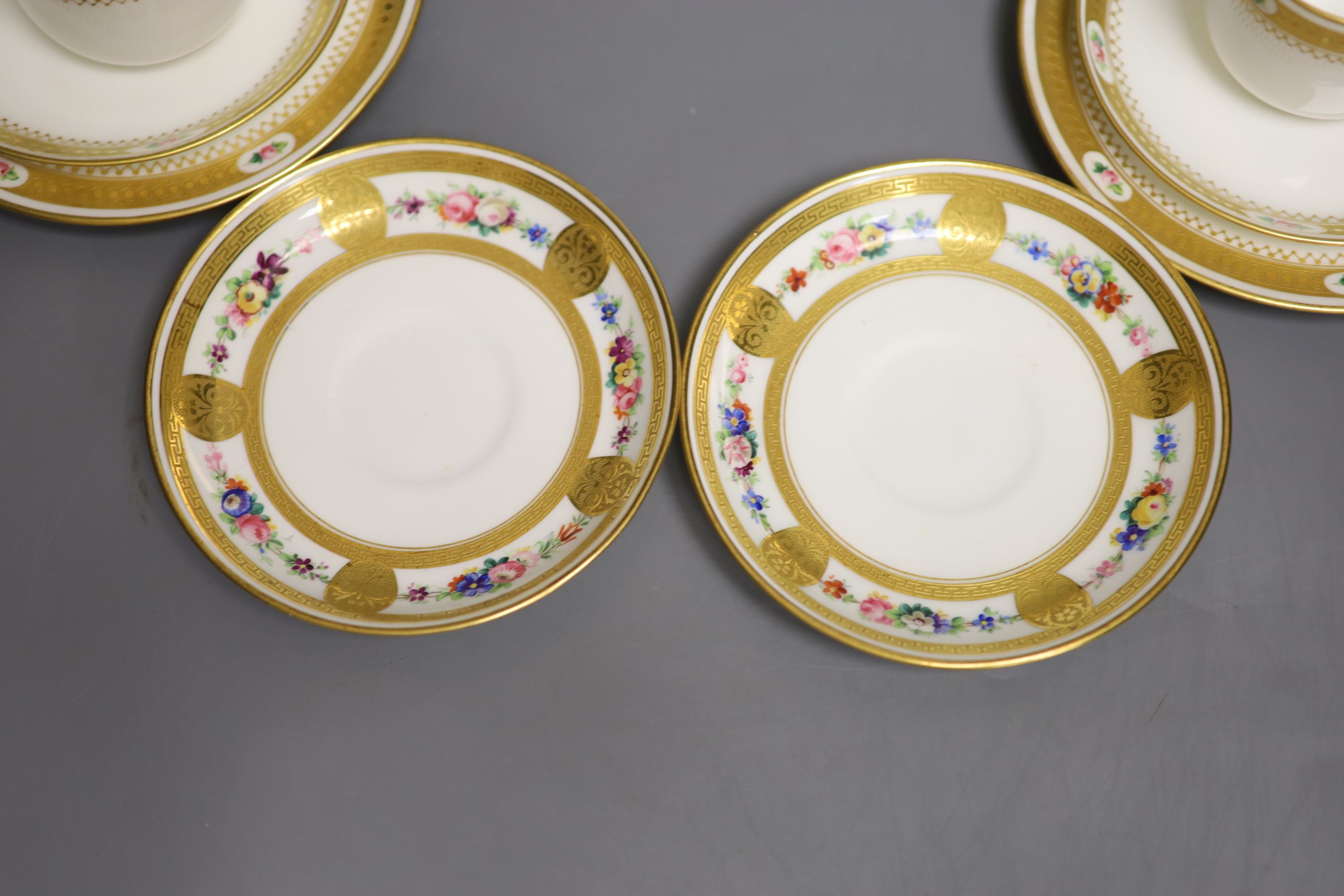 A pair of Minton coffee cups and saucers & pair Minton trios